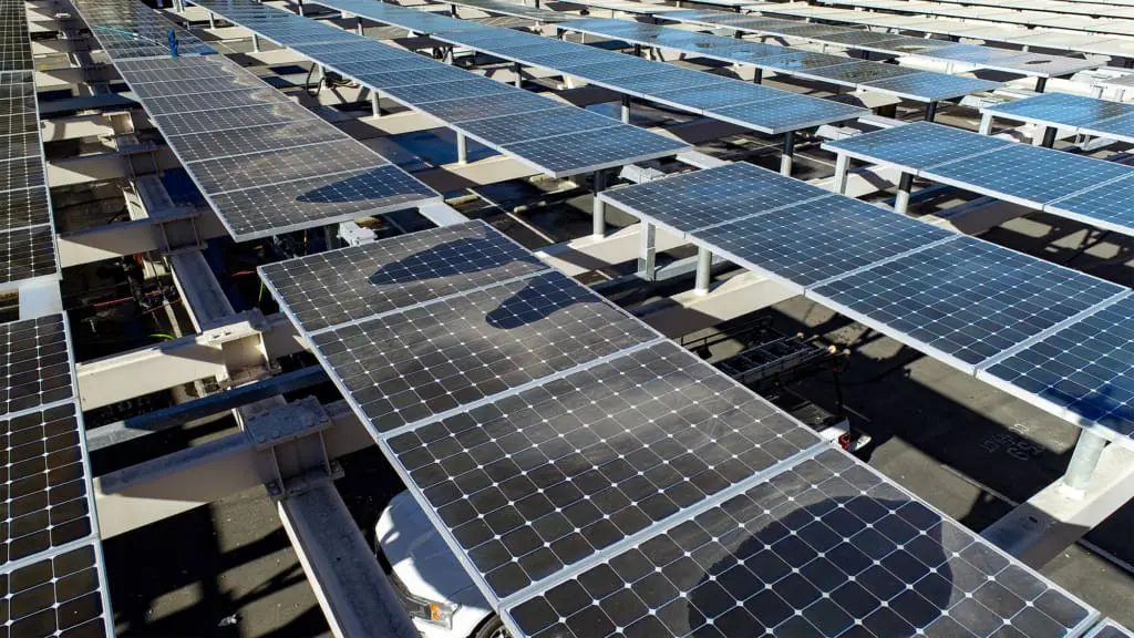 dirty solar panels with clean panels behind them