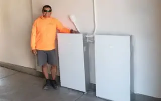 Tesla Powerwall 3 and our Synergy Power installer in a garage
