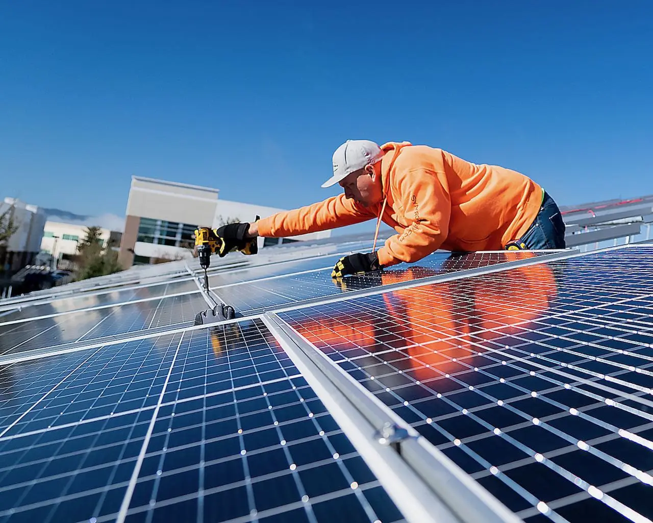 Jason Piekarczyk installing solar panels on a roof. He and his brother started Synergy Power, a solar company in Livermore CA