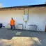 Synergy Power installer beside four Enphase IQ Battery 10C units at an Alamo home