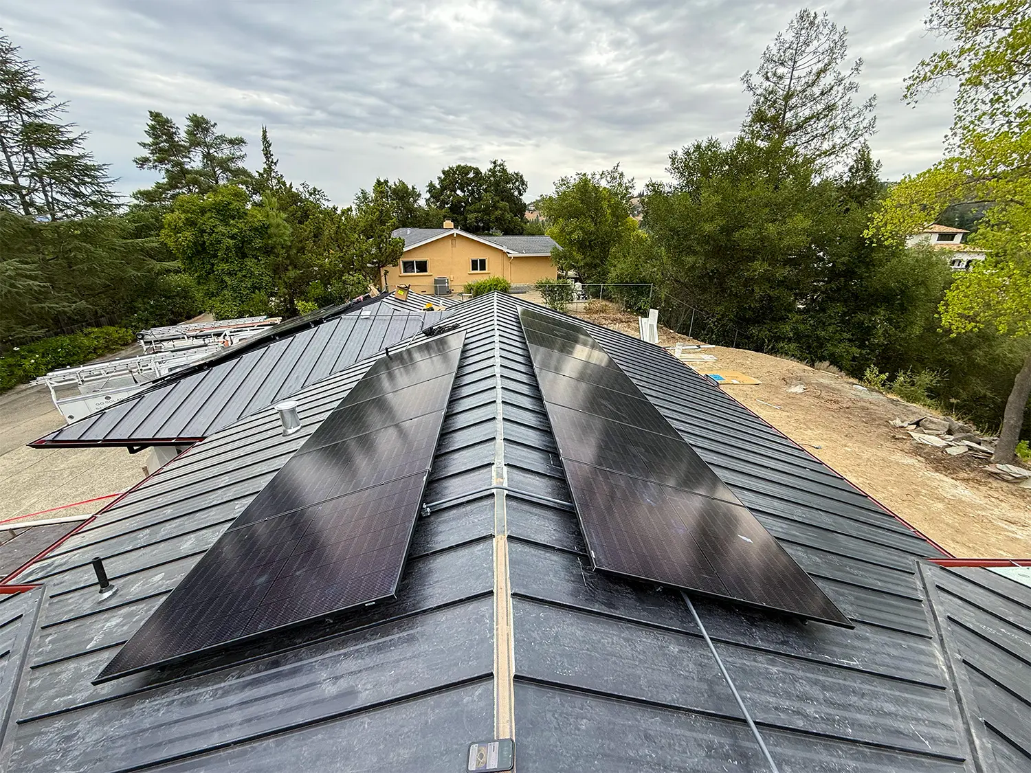 Rooftop solar panels along the metal roof of the Alamo home