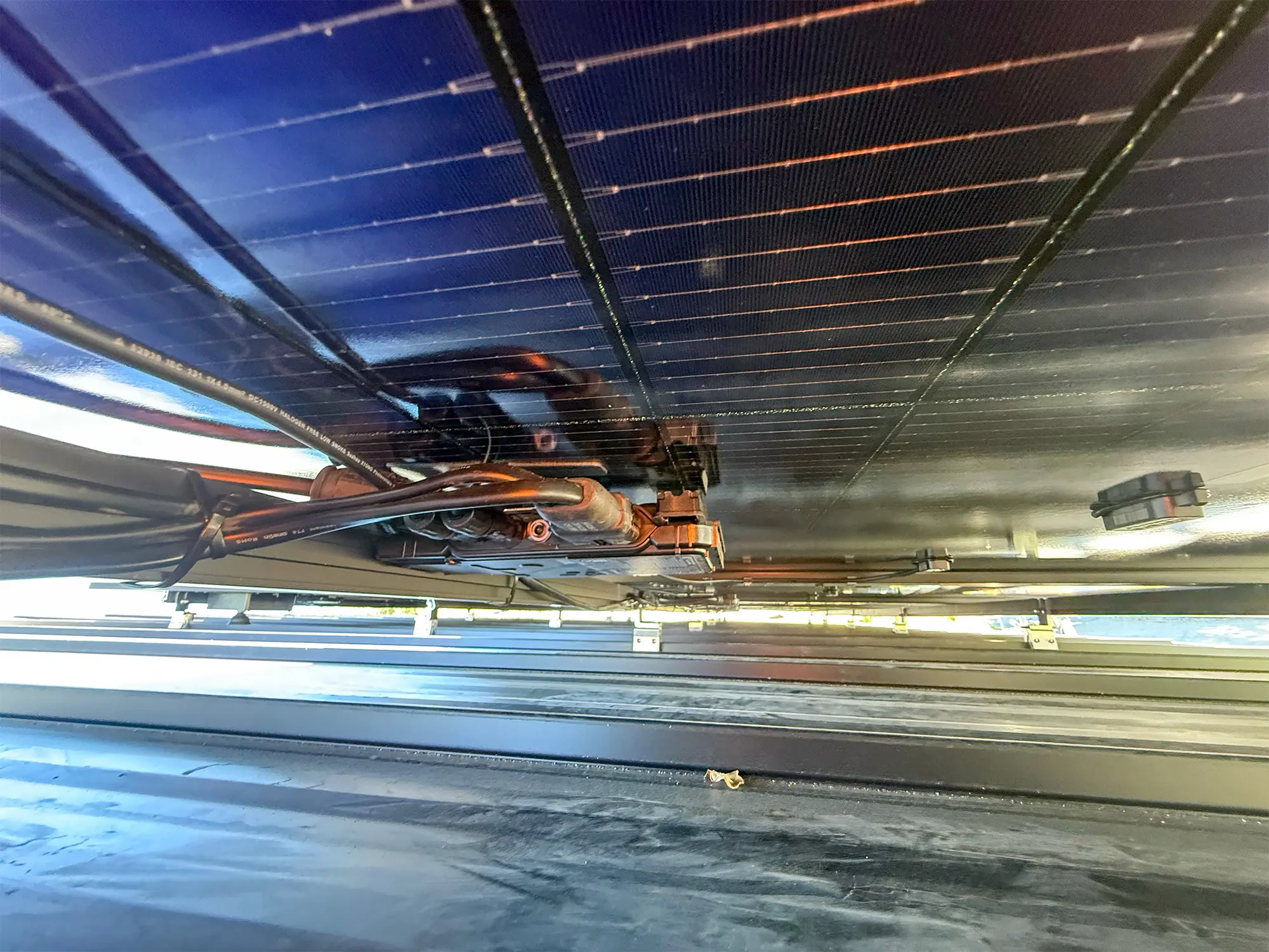 View beneath the metal roof and solar mounting structure in Alamo