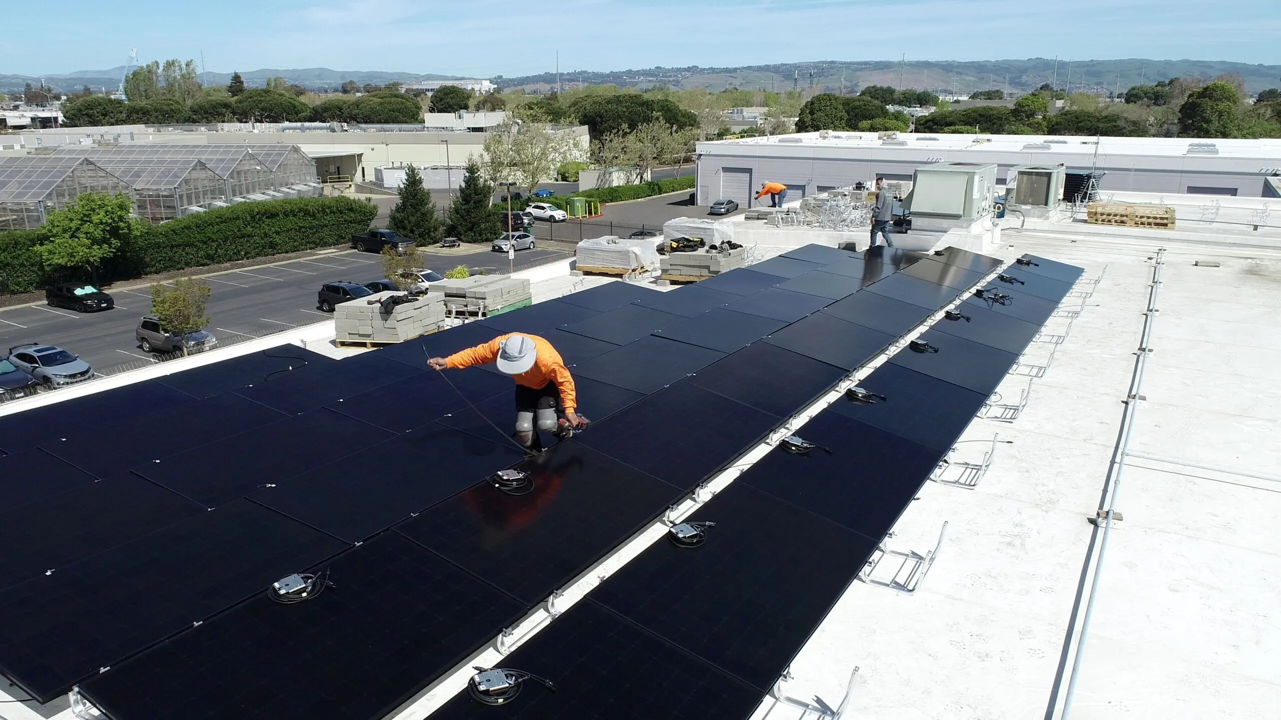 Installer working beside the Maxeon rooftop solar array in Hayward