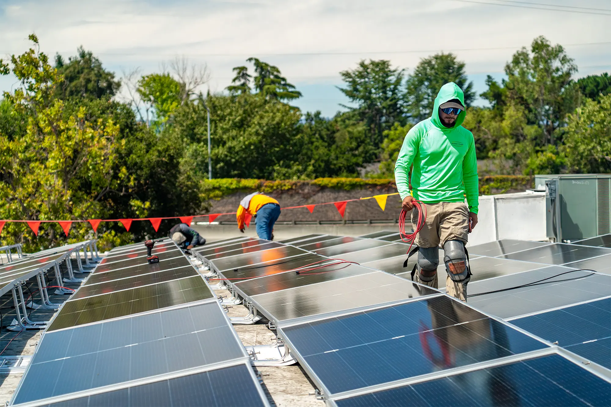 Synergy Power installers working on the Proteus Industries rooftop solar array
