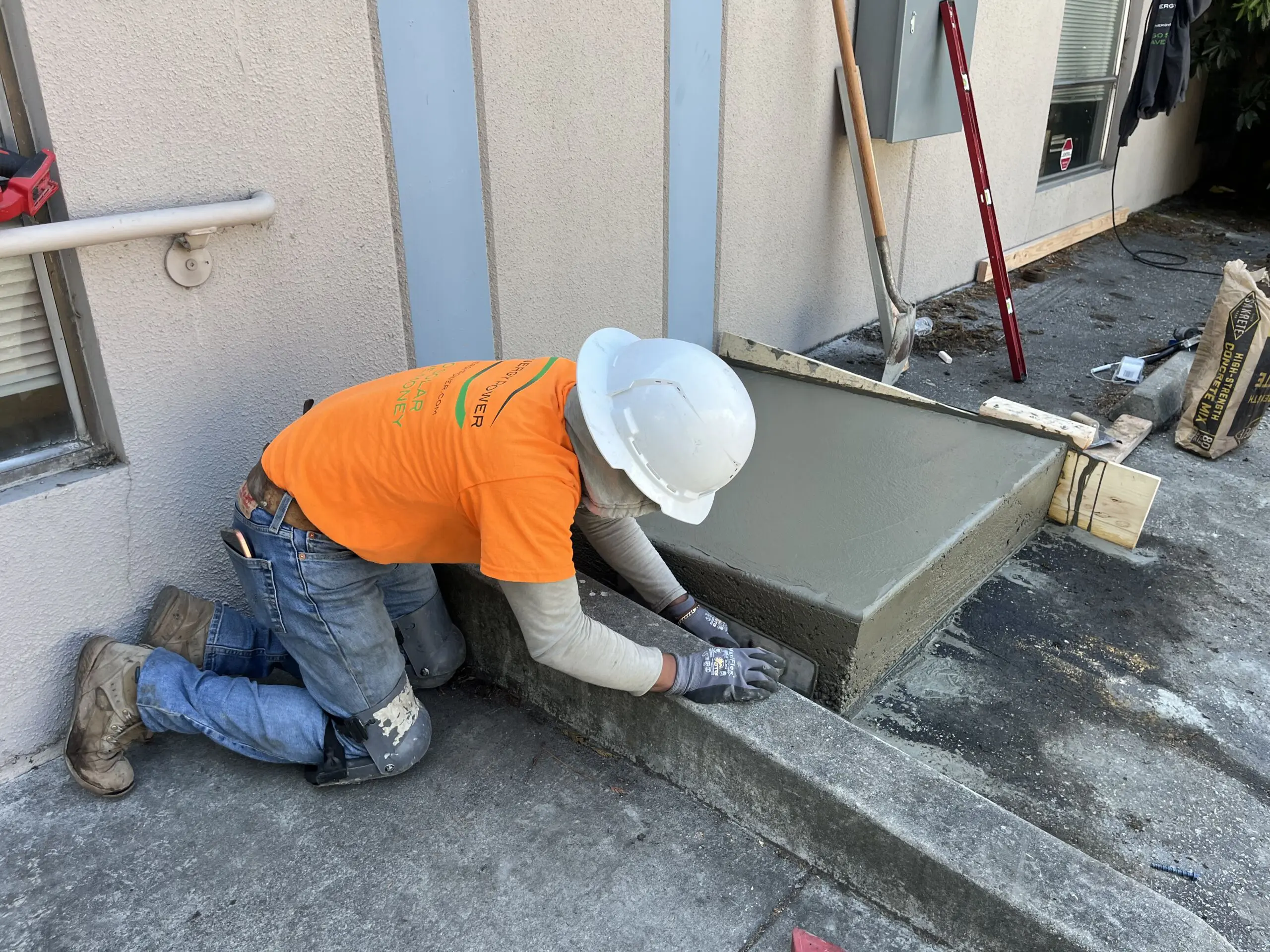 Synergy Power installer working beside electrical equipment at Proteus Industries